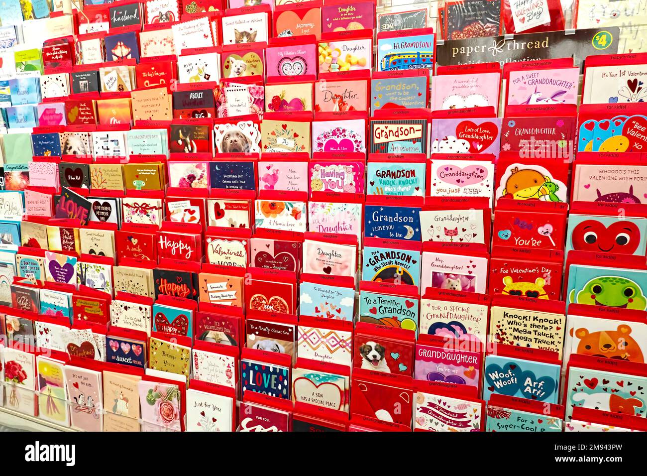 Store display of Valentine`s Day greeting cards in racks against a wall